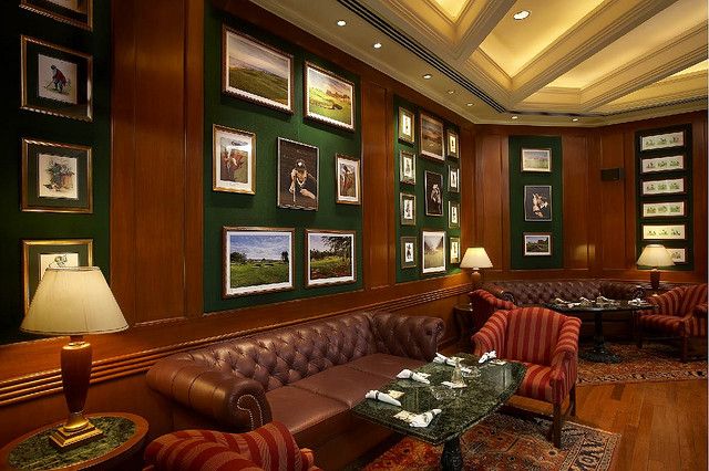 a living room filled with furniture and pictures on the wall