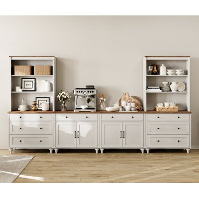 a living room filled with white furniture and lots of shelves on top of each other