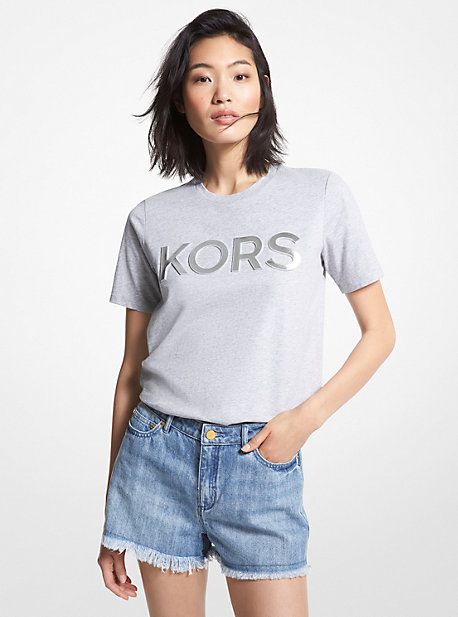 Meet your new favorite tee. Cut from soft and breathable organic cotton, this crewneck style features our “KORS” lettering in a shiny finish. Dress it up with a sleek blazer or down with your most-loved leggings. Spring Crew Neck T-shirt With Logo Lettering, Spring Cotton T-shirt With Logo Lettering, Relaxed Fit Tops With Logo Lettering For Fall, Fall Tops With Logo In Relaxed Fit, Casual T-shirt With Logo Lettering For Spring, Spring Casual T-shirt With Logo Lettering, Casual Spring T-shirt With Logo Lettering, Casual Tops With Logo Lettering, Trendy Logo Tops For Spring