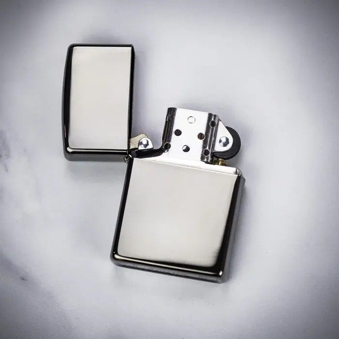 two lighters sitting next to each other on a white surface with one being opened