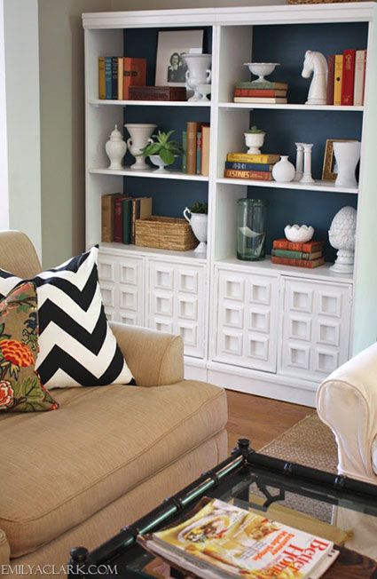 a living room filled with furniture and bookshelves