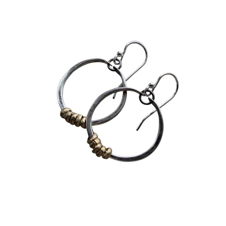 These thick hammered hoops are a great every day size. Made of 14 gauge sterling wire that has been forged, oxidized and polished to a matte finish with tiny brass Ethiopian heishi beads for a mixed metal contrast. 20 gauge sterling earwire.Just under 1" in Diameter Everyday Metal Hoop Earrings With Oxidized Finish, Artisan Small Hoop Earrings With Oxidized Finish, Artisan Small Hoop Earrings For Everyday, Artisan Oxidized Finish Earrings For Everyday, Artisan Hoop Earrings With Ear Wire For Everyday, Everyday Hand Forged Small Hoop Earrings, Minimalist Brass Earrings With Oxidized Finish, Everyday Hand Forged Metal Earrings, Artisan Hand-forged Earrings For Everyday Wear