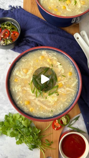 two bowls filled with soup on top of a wooden table