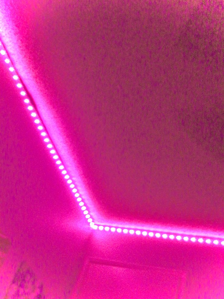 a close up of a mirror with lights on the ceiling and in front of it