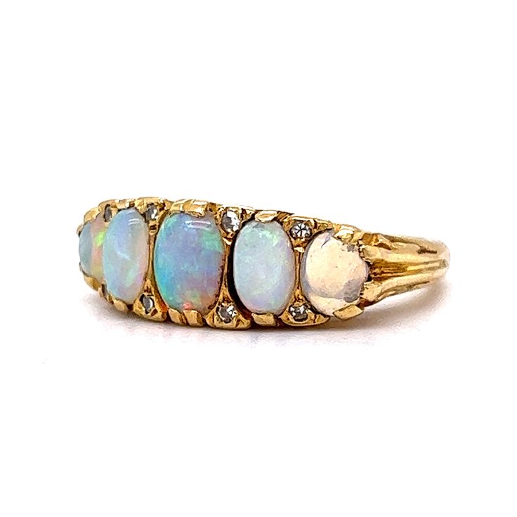 This antique Victorian era ring boasts an antique feel that will transport you to a time of glamour and luxury. Crafted from 18 karat yellow gold, this ring features beautiful cabochon opals as the primary stones and are set across the entirety of the band. The opals are complemented by eight diamonds, adding a hint of sparkle. Its timeless beauty and exceptional quality make it the perfect addition to any jewelry collection. Whether you're looking for a statement piece for a special occasion or Luxury Victorian Opal Ring, Luxury Cabochon Opal Ring, Antique Gold Opal Ring With Multi-stones, Antique Gold Multi-stone Opal Ring, Vintage Multi-stone Yellow Gold Opal Ring, Victorian Style Gold Opal Ring With Multi-stone, Vintage Opal Cabochon Ring, Gold Multi-stone Opal Ring With Oval Cabochon, Heirloom Style Formal Opal Cabochon Ring