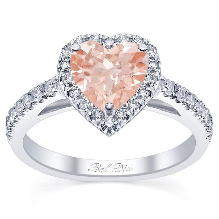 a heart shaped pink diamond ring with diamonds around it