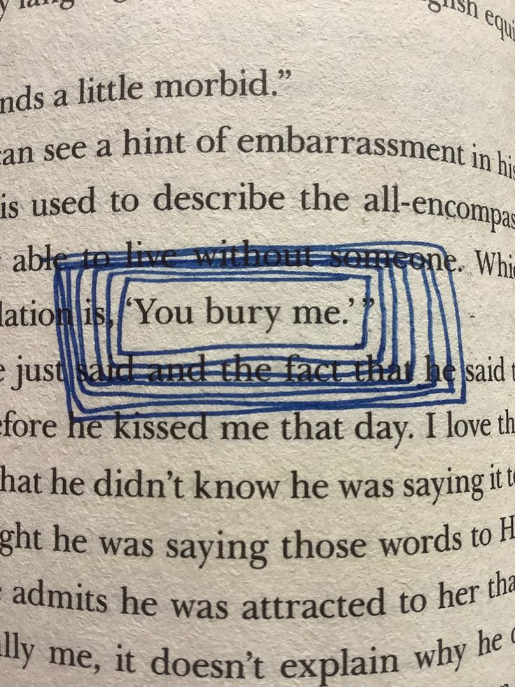 a close up of an open book with writing on the page and blue lines in it