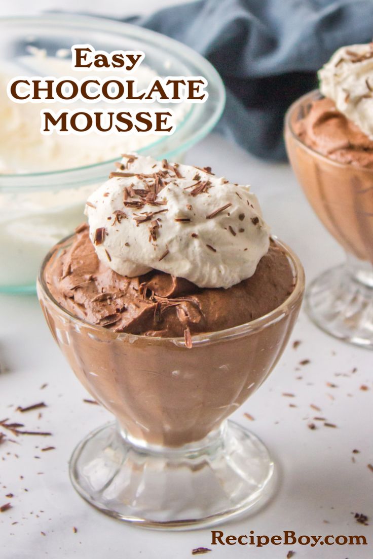 two glasses filled with chocolate mousse and whipped cream