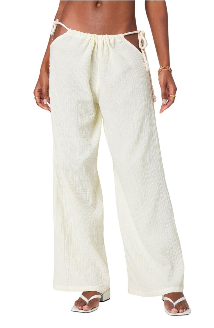 Daring hip cutouts with rope-style ties pay homage to Y2K in vacation-ready pants cut from fresh cotton gauze and boasting a breezy wide-leg fit. Drawstring waist with side ties 100% cotton Machine wash, line dry Imported Beach Straight Pants With Drawstring, Cotton Beach Pants With Tie Waist, Cotton Wide Leg Bottoms For Beach Season, Cotton Wide Leg Pants For Beach Season, Breezy Wide Leg Cotton Bottoms, Wide Leg Cotton Bottoms For Beach Season, Cotton Pants With Tie Waist For Beach, Wide Leg Cotton Pants For Beach Season, Cotton Parachute Pants For Spring Vacation