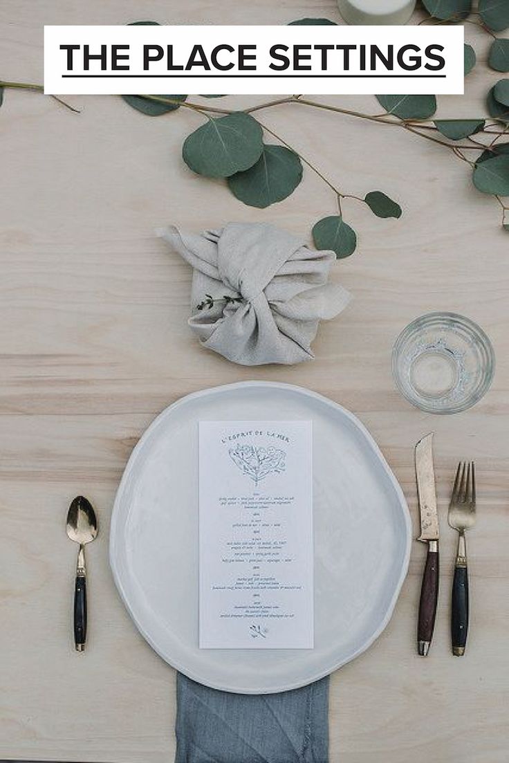 the table is set with silverware, napkins and place settings for an elegant dinner