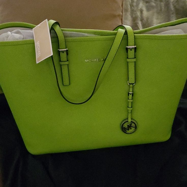 Here We Have Michel Kors Bag Could Not Use After Bought Changed Color Of Outfit For Gathering So Did Not Go With New Outfit Beautiful Bag And Color Can Even Use For Laptop If You Like Designer Green Bags With Branded Hardware, Green Shopping Bag With Branded Hardware, Green Tote Bag With Branded Hardware, Green Michael Kors Leather Bag, Green Leather Michael Kors Bag, Michael Kors Green Satchel Bag, Green Shoulder Bag With Branded Hardware For Errands, Michael Kors Travel Bags With Large Capacity, Michael Kors Large Capacity Travel Bag