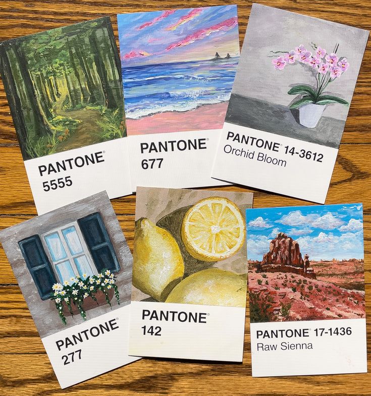 five paintings are shown on the table with each individual's name and address card