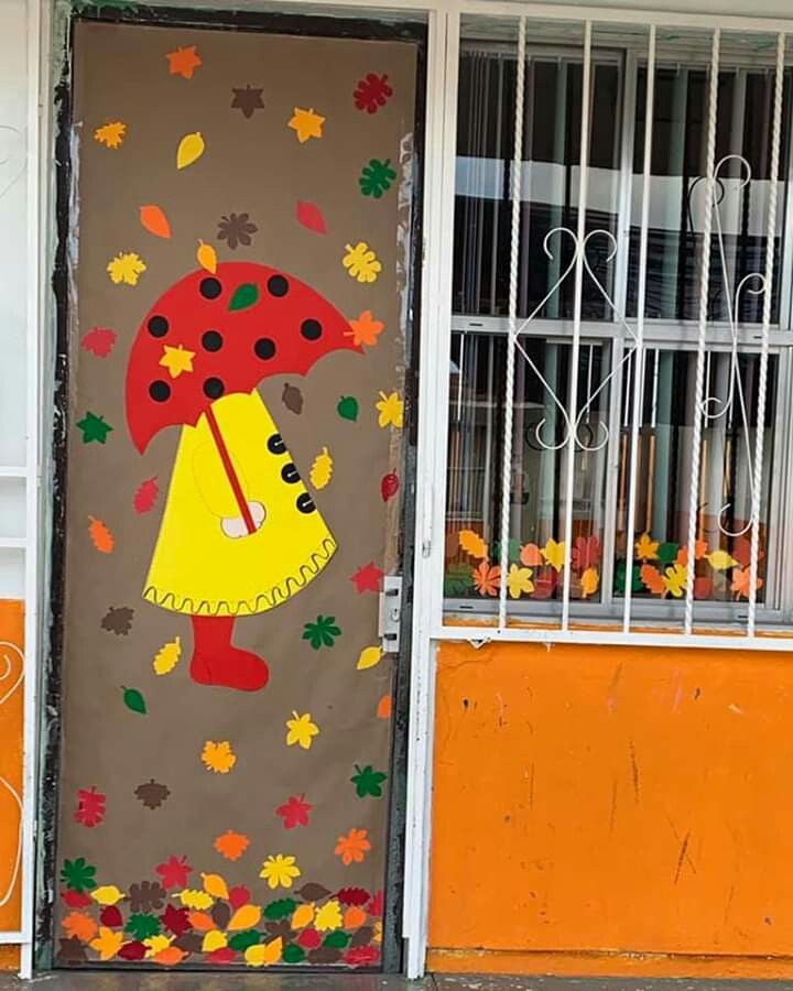 a door with an umbrella painted on it in front of a building that has orange and yellow walls