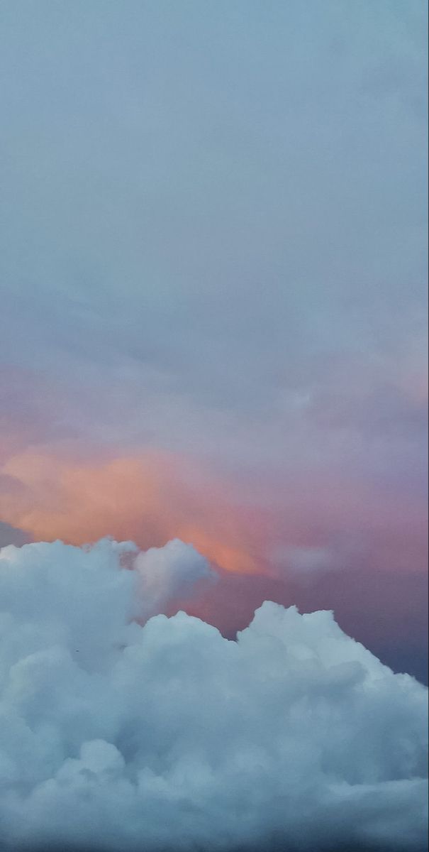 an airplane is flying high in the sky with clouds around it and one plane has just taken off