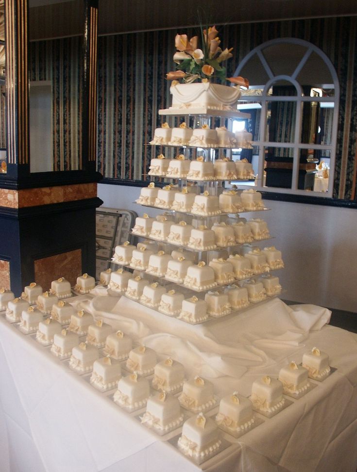 a wedding cake is stacked on top of each other in the middle of a table