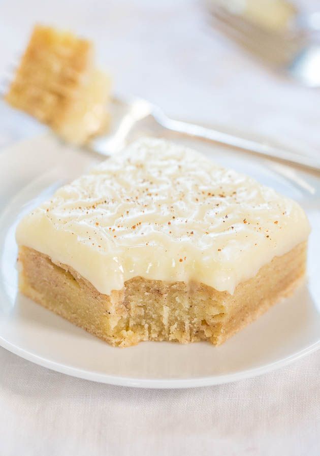 a piece of cake sitting on top of a white plate next to a fork and knife