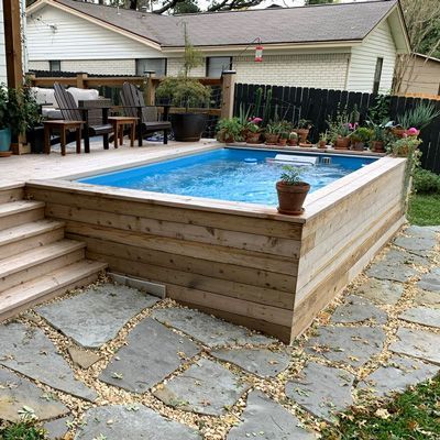 an above ground pool with steps leading up to it and a deck in the background