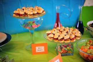 a table topped with lots of different types of food and desserts next to each other