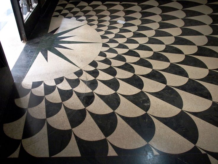 a black and white floor with an intricate design on it's side door way