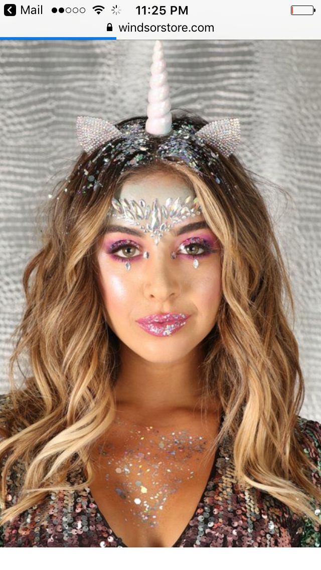 a woman with unicorn makeup and glitter on her face