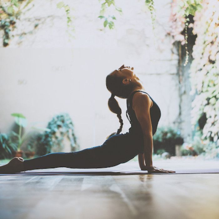 a woman is doing yoga on the floor