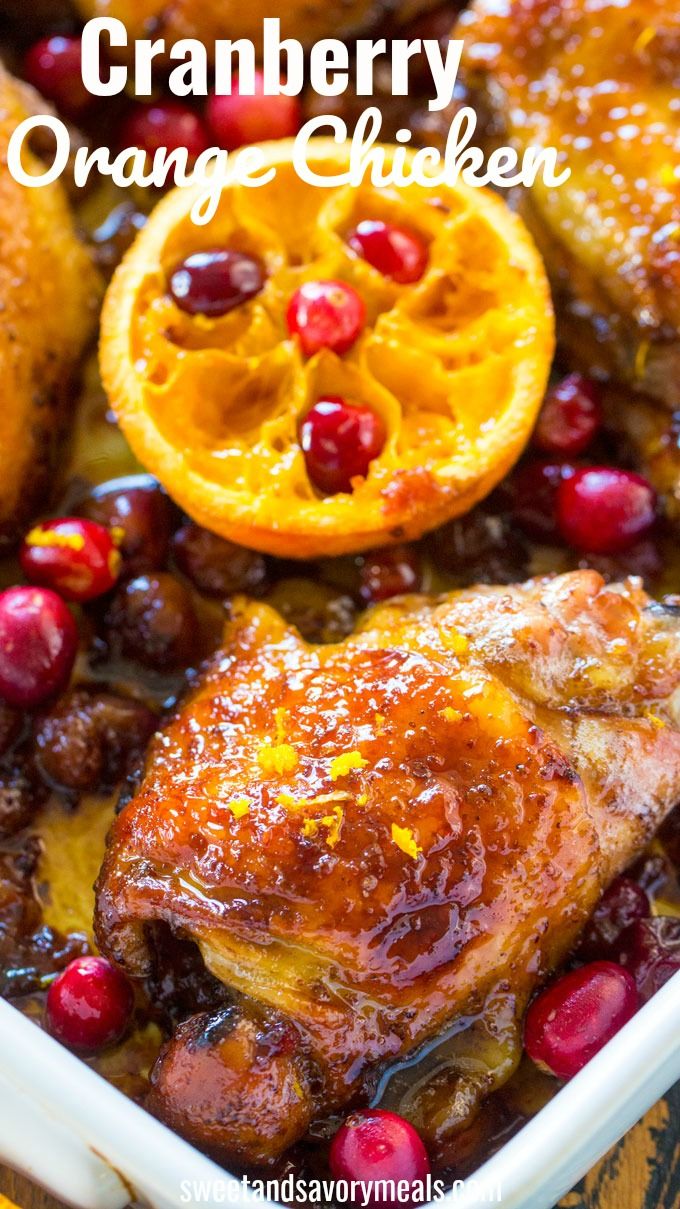 baked chicken with cranberries and oranges in a white casserole dish