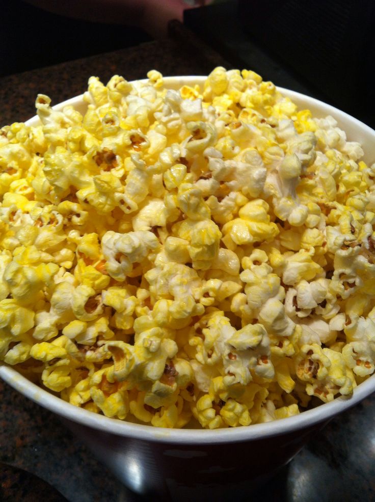 a bowl filled with popcorn sitting on top of a counter