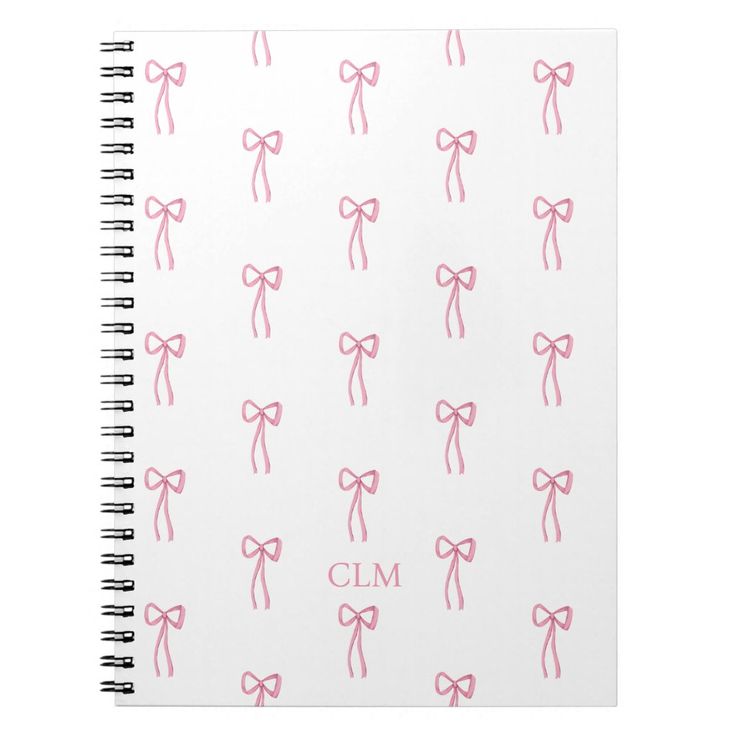 a notebook with pink bows and the word cm on it's front cover is shown