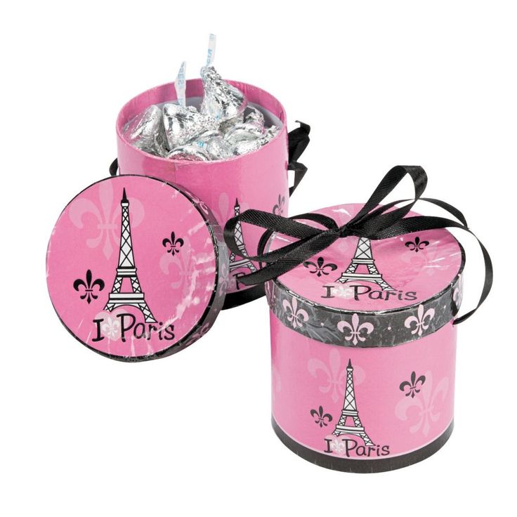 two pink tins with the eiffel tower on them, one is wrapped in black ribbon