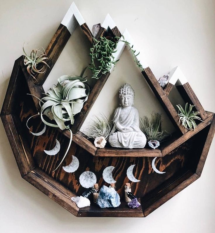 a wooden shelf with plants and statues on it's sides, in the shape of a hexagonal pyramid