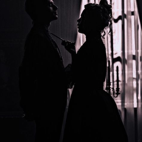 the silhouette of two people standing next to each other in front of a window with curtains