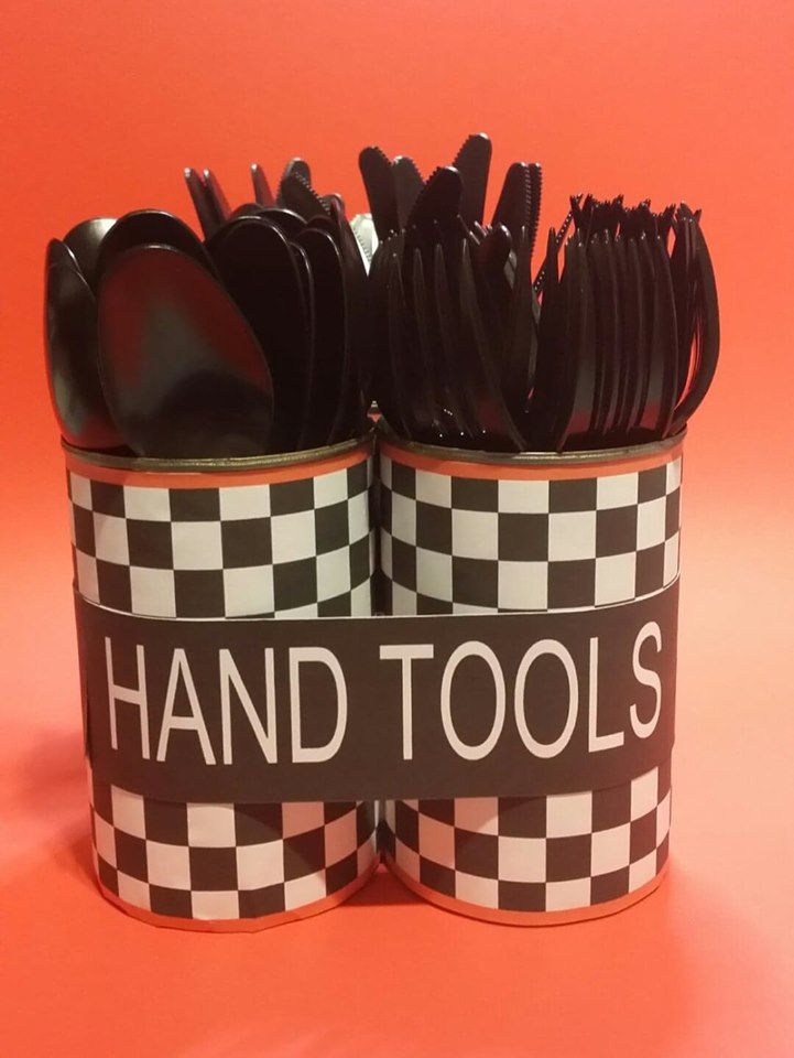 two black and white checkered cups with spoons in them on an orange background