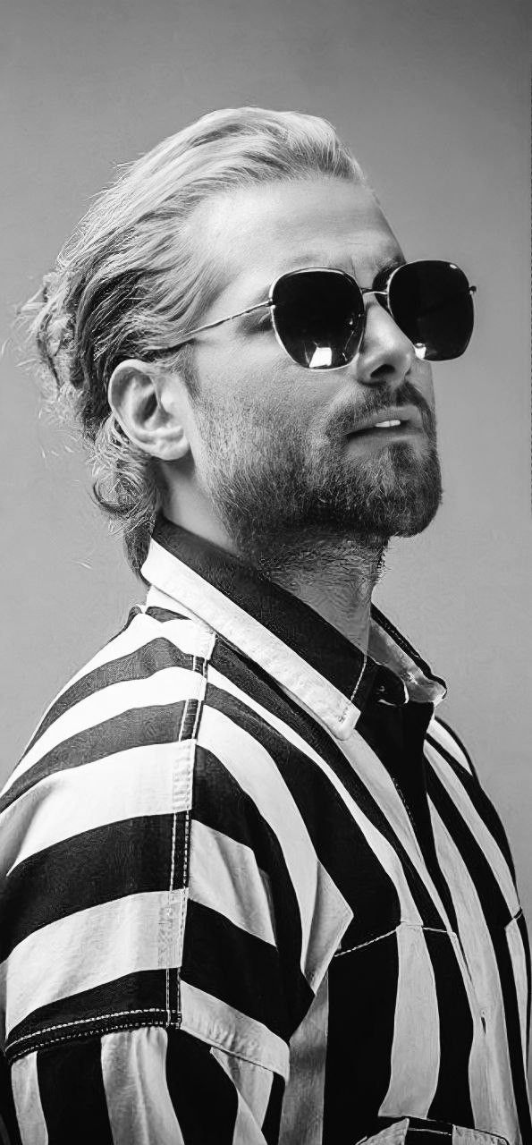 a man wearing sunglasses and a striped shirt