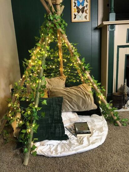 a bed that has some lights on it in the middle of a room with a fireplace