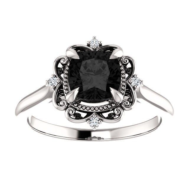 a black and white diamond ring on a white background