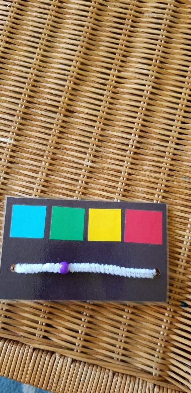 a piece of paper that has been placed on a wicker chair with some colored pencils in it