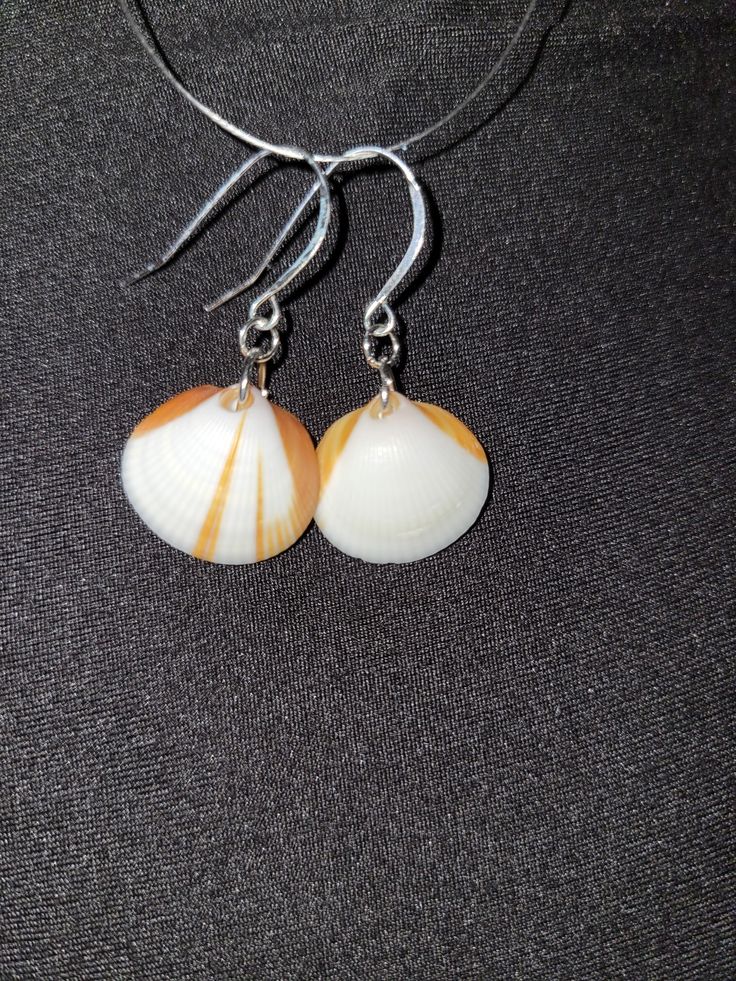 Hand made, hand picked from brevard county beaches Unique Nickel-free Earrings For Beach, Orange Dangle Jewelry For Beach, Orange Drop Earrings For Beach, Orange Drop Earrings For The Beach, Unique White Beach Earrings, Handmade Coastal Jewelry For Gifts, Handmade Coastal Style Jewelry Gift, Unique Round Earrings For Beach, Nickel-free Orange Jewelry For Beach