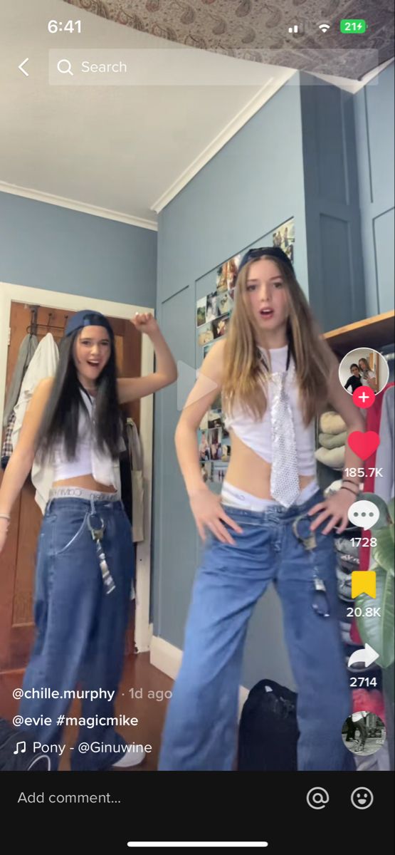 two young women are dancing in the living room with their hands on their hipss