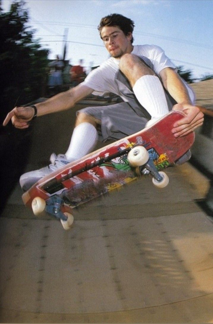 a man riding a skateboard up the side of a ramp