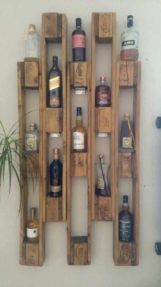 a wall mounted shelf with liquor bottles on it