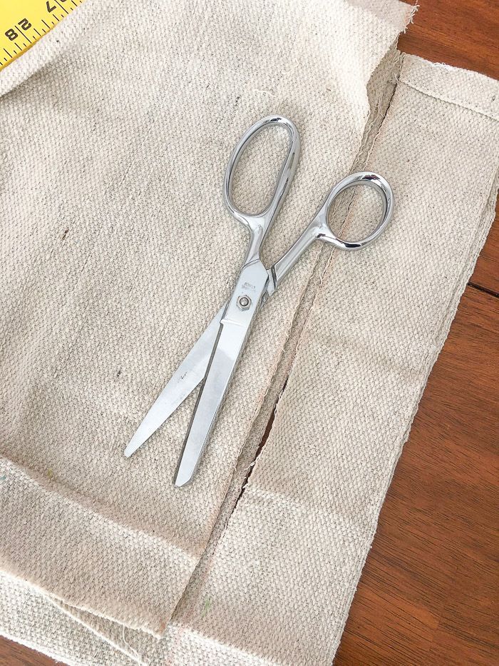 a pair of scissors sitting on top of a piece of cloth