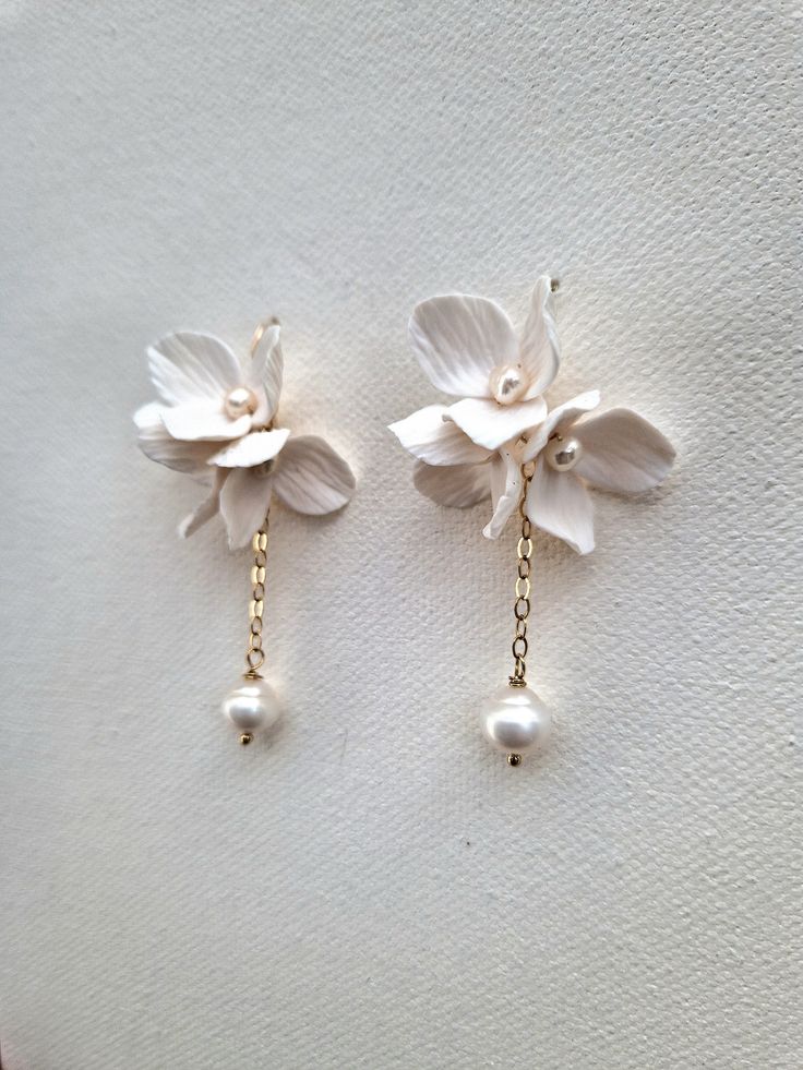 Delicate handmade 'Lucy' flowers arranged into beautiful cluster earrings with a dangling freshwater baroque pearl will make your bridal look extra special. Each flower is adorned with nugget pearl and attached to gold-filled or sterling hook earrings and gold filled or sterling silver chain. The total length of the earring is 4.5cm. Sent beautifully packaged in a Medze Bride gift box. As 'LUCY' earrings are made to order especially for you as well due to hygienic reasons I cannot accept refunds Handmade Bridal Earrings, Diy Bridal Earrings, White 14k Gold Filled Bridal Earrings As Gift, 14k Gold Filled White Bridal Earrings As Gift, Delicate White 14k Gold Filled Earrings, White 14k Gold Filled Earrings For Weddings, 14k Gold Filled White Bridal Earrings For Wedding, White 14k Gold Filled Bridal Earrings For Wedding, White 14k Gold-filled Pearl Earrings For Wedding