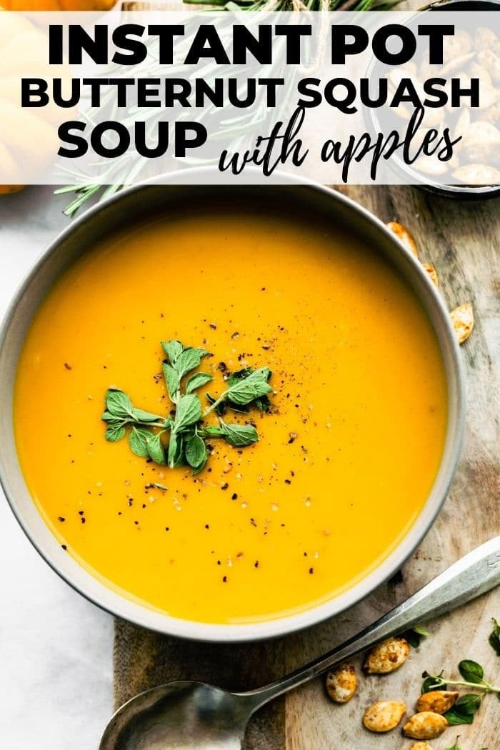 a bowl of instant pot butternut squash soup with apples and herbs in the background