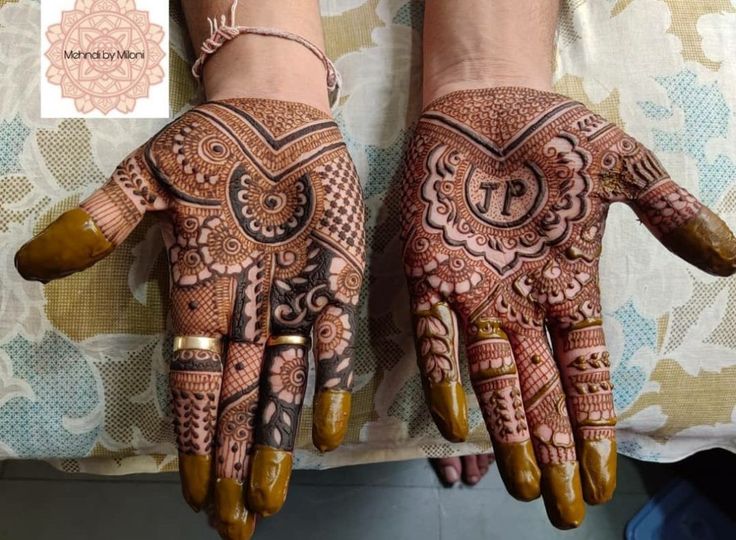 two hands with henna designs on them