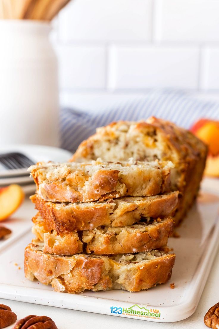 slices of bread sitting on top of a cutting board next to pecans and oranges