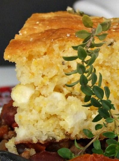 a close up of a plate of food with meat and bread on it's side