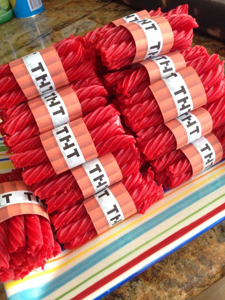 there are many pieces of red yarn wrapped in tape on top of a countertop