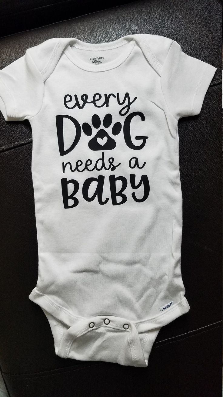 a white bodysuit that says, every dog needs a baby