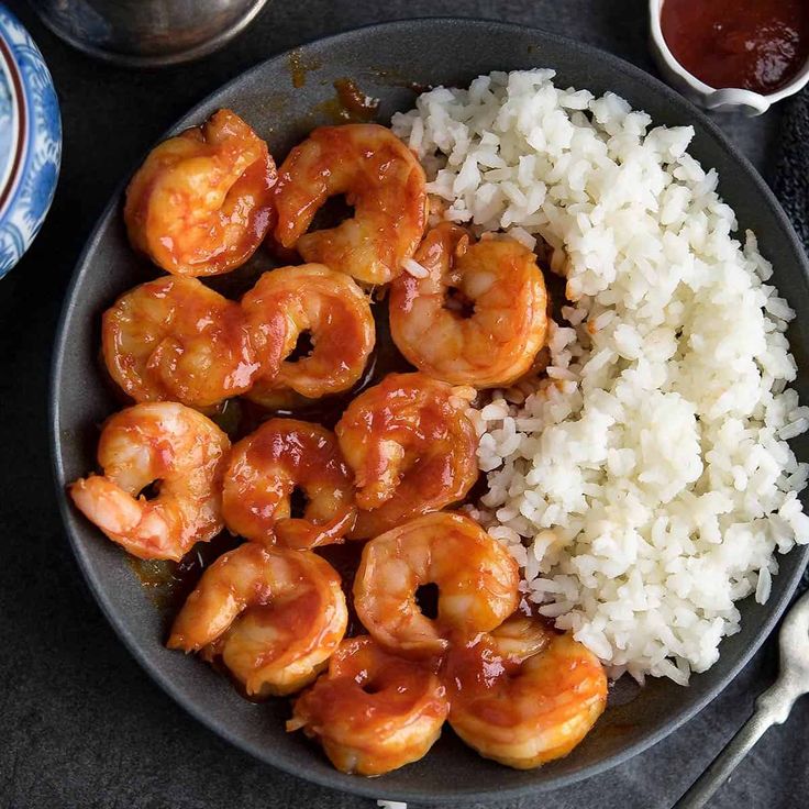 shrimp and rice on a plate with silverware