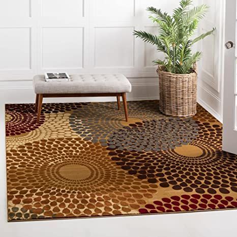 a living room area with a rug and potted plant